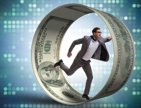 Businessman in hamster wheel chasing dollarsの写真素材