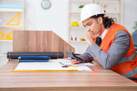 Young male architect working in the officeの写真素材