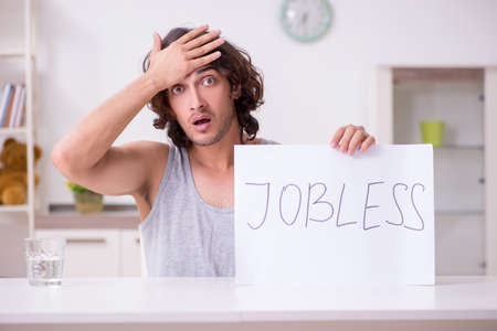 Unemployed man desperate at homeの写真素材