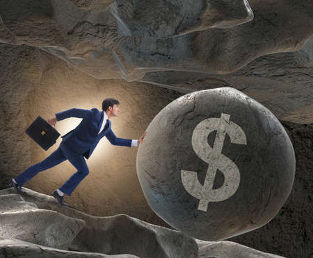 Businessman pushing dollar sign in business conceptの写真素材