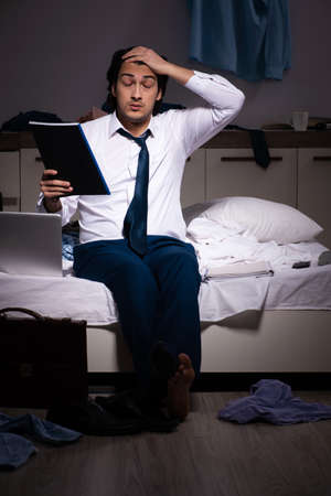 Young employee working at home after night shiftの写真素材