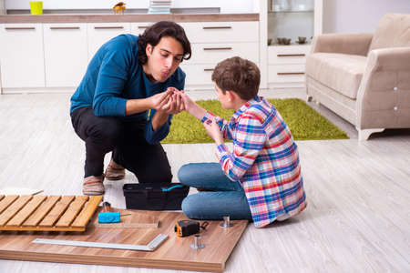 Young carpenter teaching his sonの写真素材