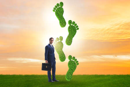 Carbon footprint concept with businessmanの写真素材