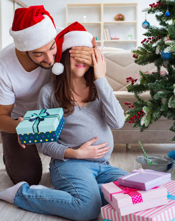 Young family expecting child baby celebrating christmasの写真素材