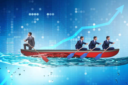Disagreement concept with businessmen rowing in different directionsの写真素材