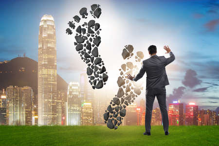 The carbon footprint concept with businessmanの写真素材