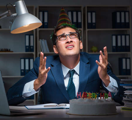 Man celebrating birthday in the officeの写真素材