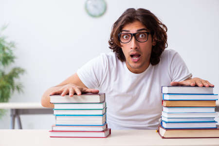 Young male student sitting in the classroomの写真素材