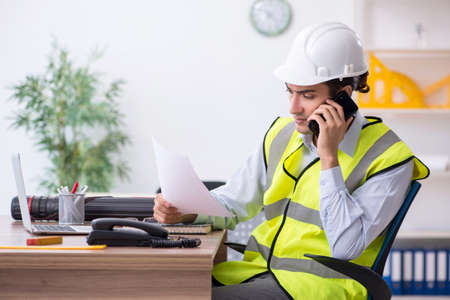 The young male architect working in the office