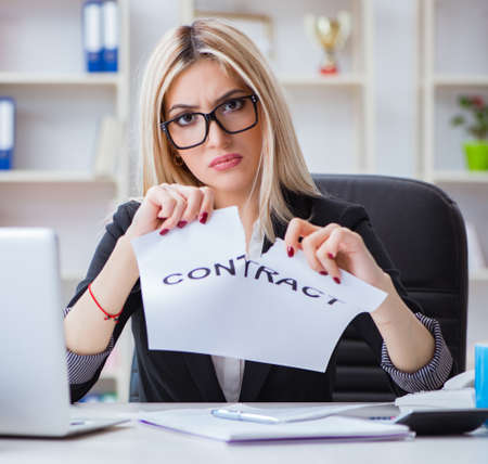 Young businesswoman with message in the officeの写真素材