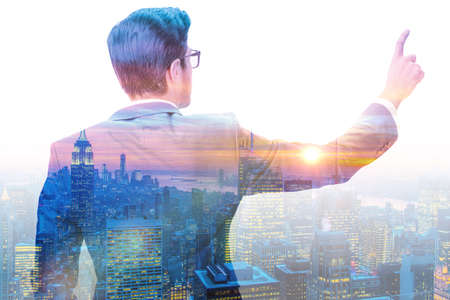 The successful businessman against cityscape in business conceptの写真素材