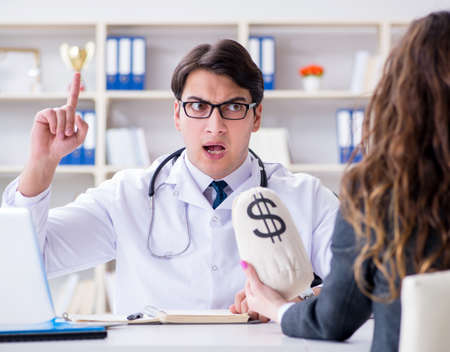 Young doctor in medical insurance fraud conceptの写真素材