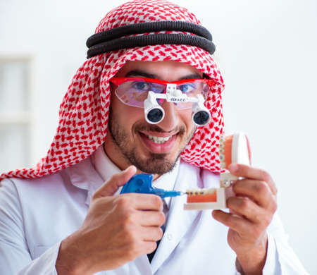 The arab dentist working on new teeth implantの写真素材