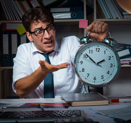 Man businessman working late hours in the officeの写真素材
