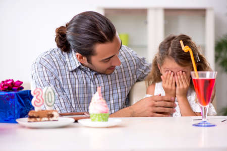 The father celebrating birthday with his daughterの写真素材