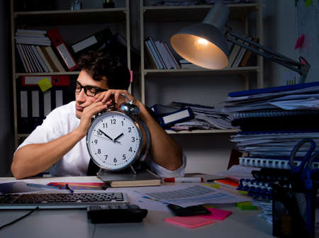 The man businessman working late hours in the office