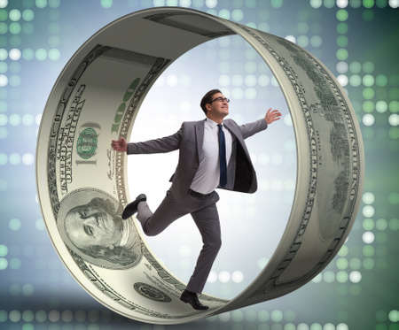 Businessman in hamster wheel chasing dollarsの写真素材