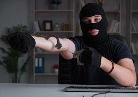 Hacker hacking computer late at nightの写真素材