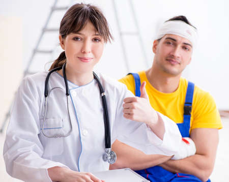 Worker with injured head and doctor