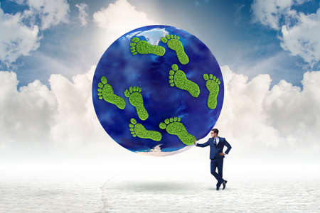 The carbon footprint concept with businessmanの写真素材