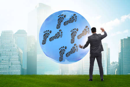 The carbon footprint concept with businessmanの写真素材