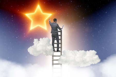 The businessman reaching out for stars