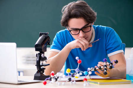 Young male student in the classroomの写真素材