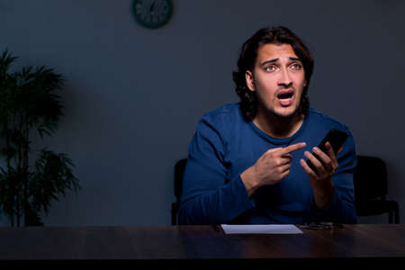 Young convict man sitting in dark room