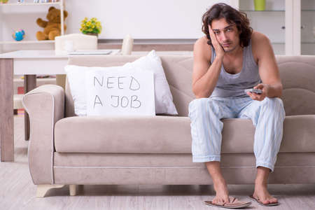 Unemployed man desperate at homeの写真素材