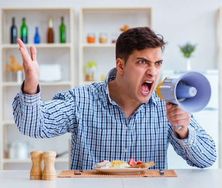 Husband with loudspeaker yelling at his wifeの写真素材