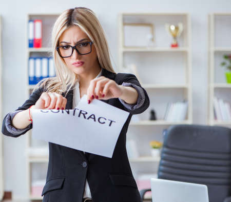 Young businesswoman with message in the officeの写真素材