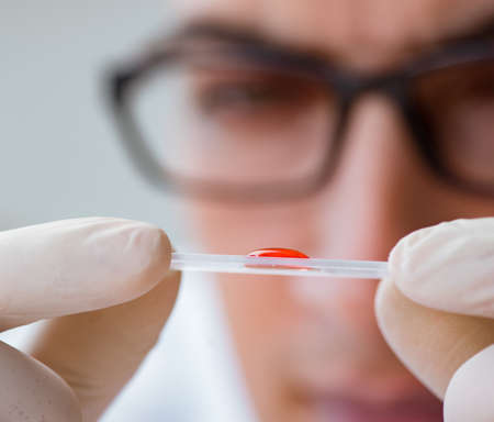 Young doctor doing the blood test