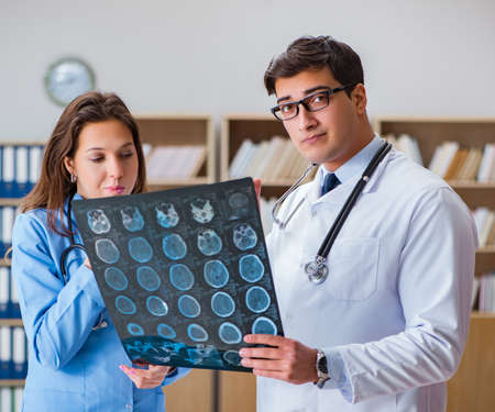 Young doctor looking at computer tomography x-ray image