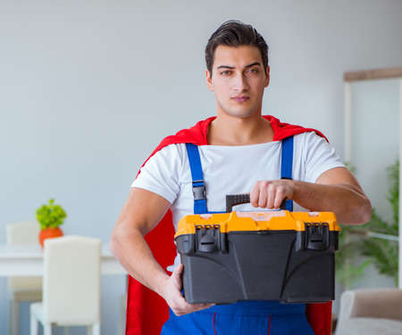 Super hero repairman working at homeの写真素材