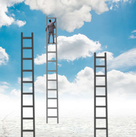 The businessman climbing stairs against the skyの写真素材