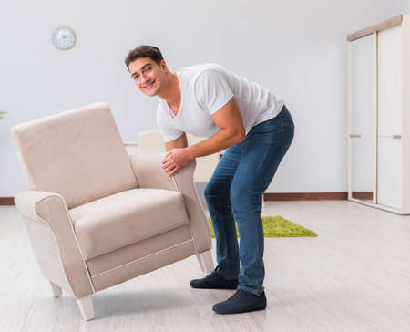 Man moving furniture at homeの写真素材