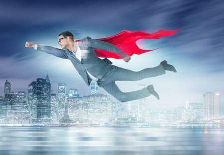 Businessman in superhero concept with red coverの写真素材