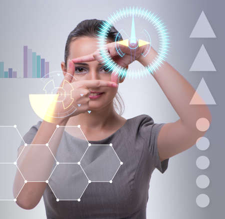Businesswoman pressing virtual buttons in business conceptの写真素材