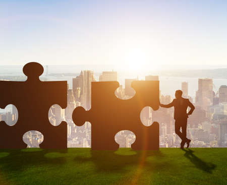 The business metaphor of teamwork with jigsaw puzzleの写真素材