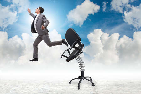 Promotion concept with businessman ejected from chairの写真素材