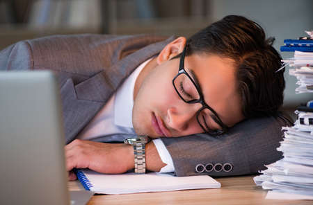 Businessman staying in the office for long hoursの写真素材