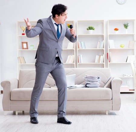 Drunk businessman celebrating in the officeの写真素材