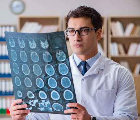 Young doctor looking at computed tomography x-ray image