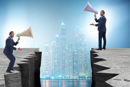 Businessman shouting with loudspeaker at each otherの写真素材