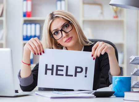 Young businesswoman with message in the officeの写真素材