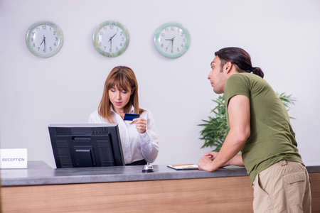 Young man at the hotel reception
