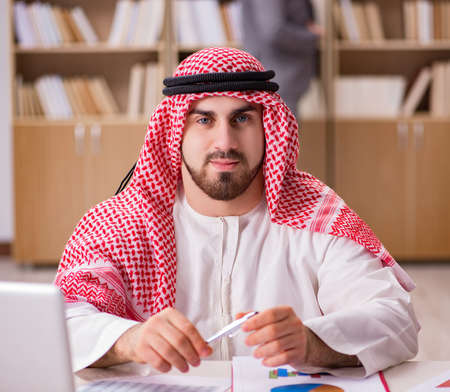 Arab businessman working on laptop computerの写真素材