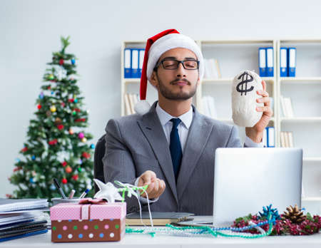 Young businessman celebrating christmas in the officeの写真素材