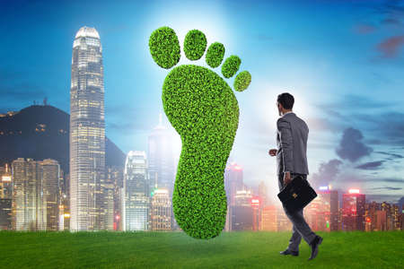Carbon footprint concept with businessmanの写真素材