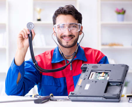 Repairman working in technical support fixing computer laptop tr
